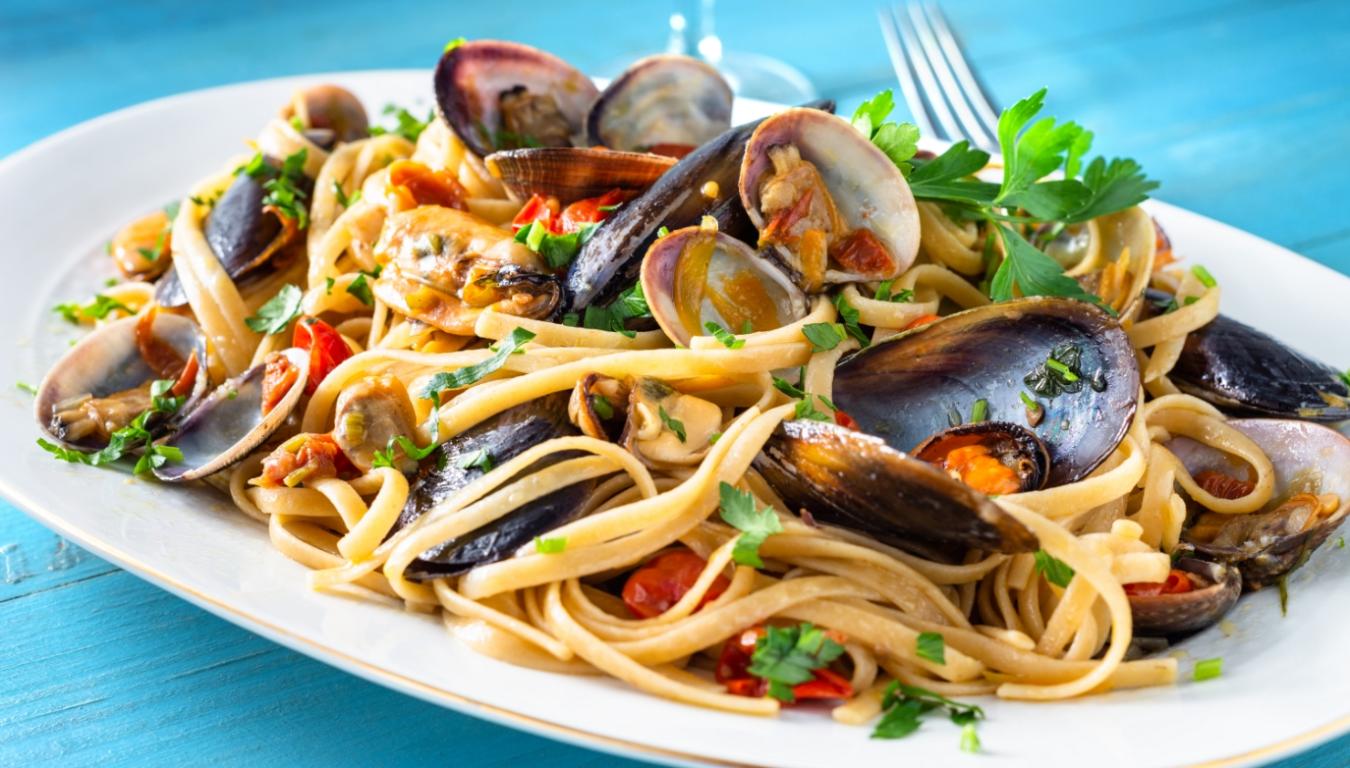 Linguine ai frutti di mare con cozze, vongole e prezzemolo fresco.